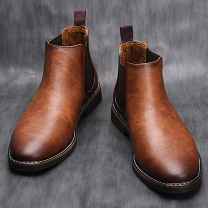 Pair of brown leather boots on a gray background
