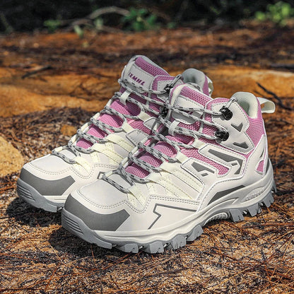 Pair of pink and gray hiking shoes on a wooden surface