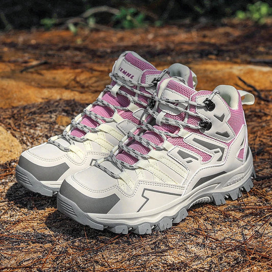 Pair of pink and gray hiking shoes on a wooden surface