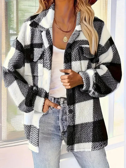 Person wearing a black and white checkered jacket with a blurred background