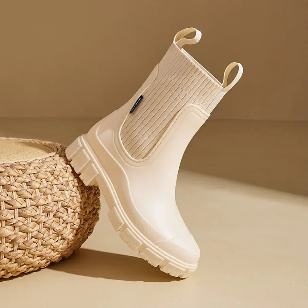 Beige rubber boot with white sole on a beige background