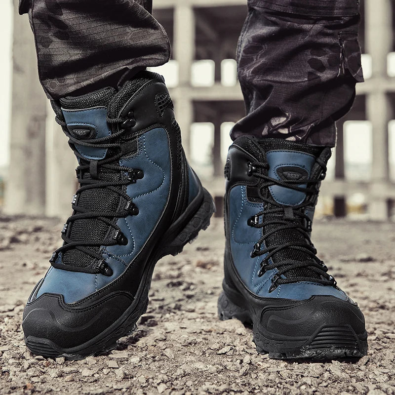 Blue and black tactical boots worn by a person on a gravel surface.