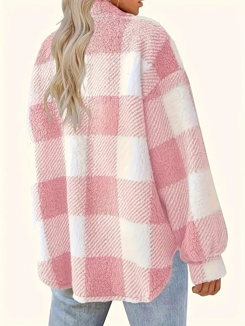 Person wearing a pink and white checkered fleece jacket on a white background
