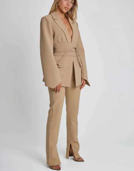 Woman wearing a beige suit on a white background