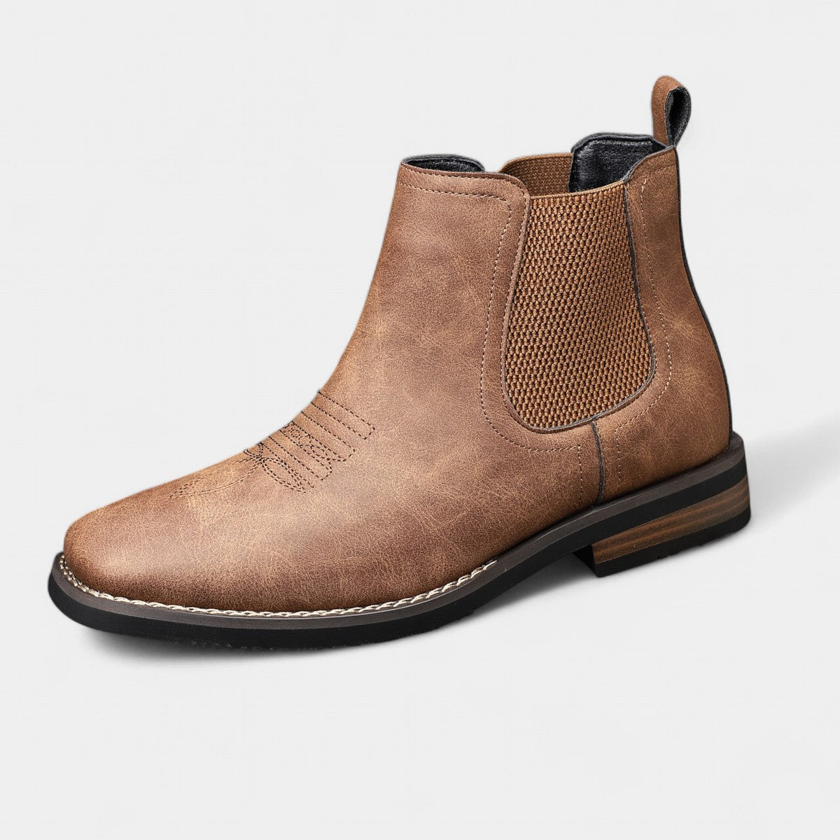 Brown leather Chelsea boot on a light gray background