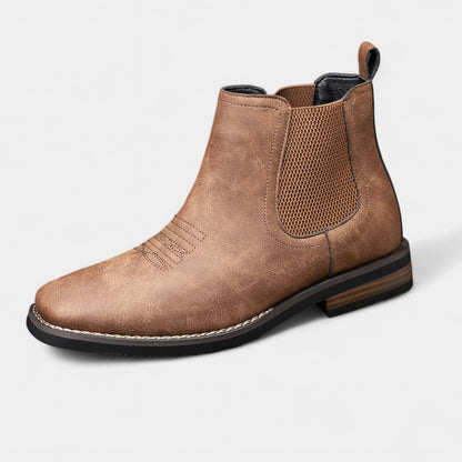 Brown leather Chelsea boot on a light gray background