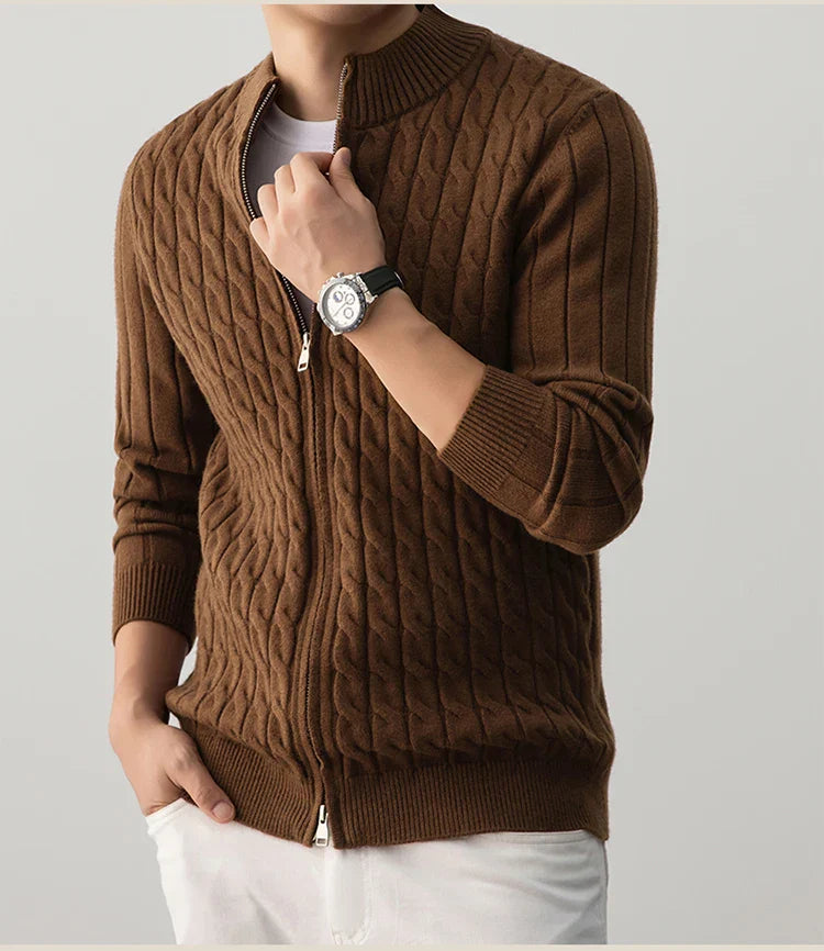 Brown cable knit sweater worn by a person on a plain background