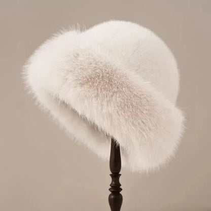 White fur hat on a wooden stand against a beige background
