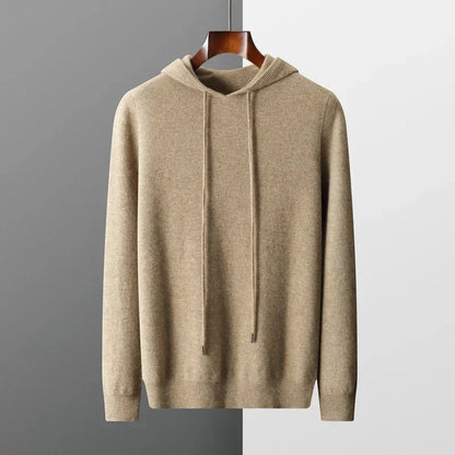 Beige hoodie on a hanger against a gray background