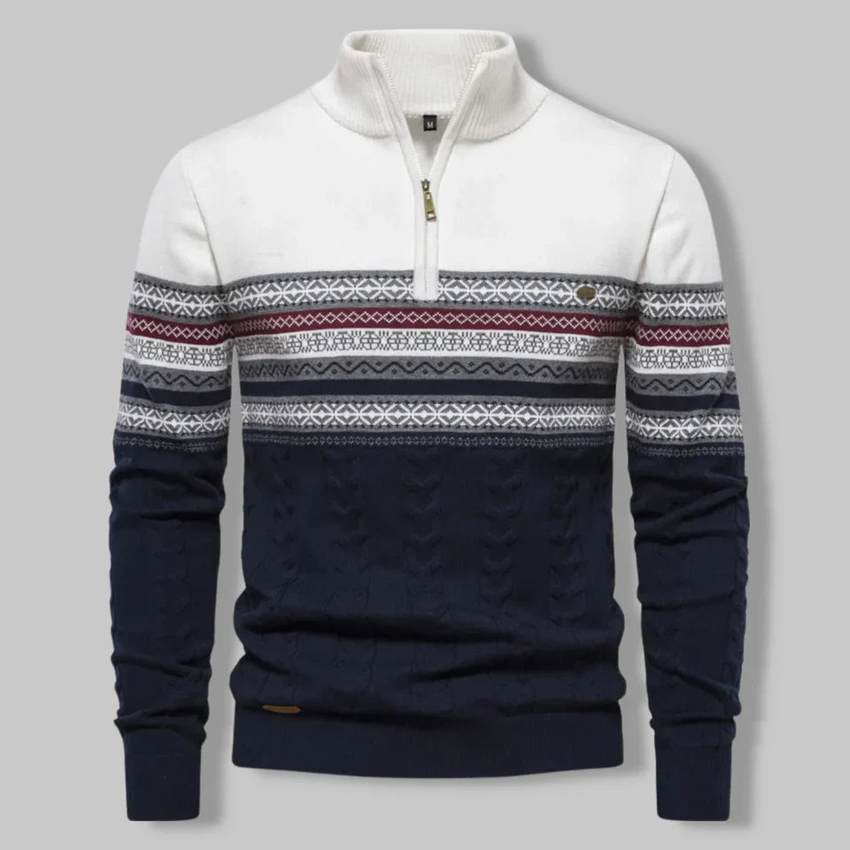 Navy and white sweater with patterned sleeves on a gray background