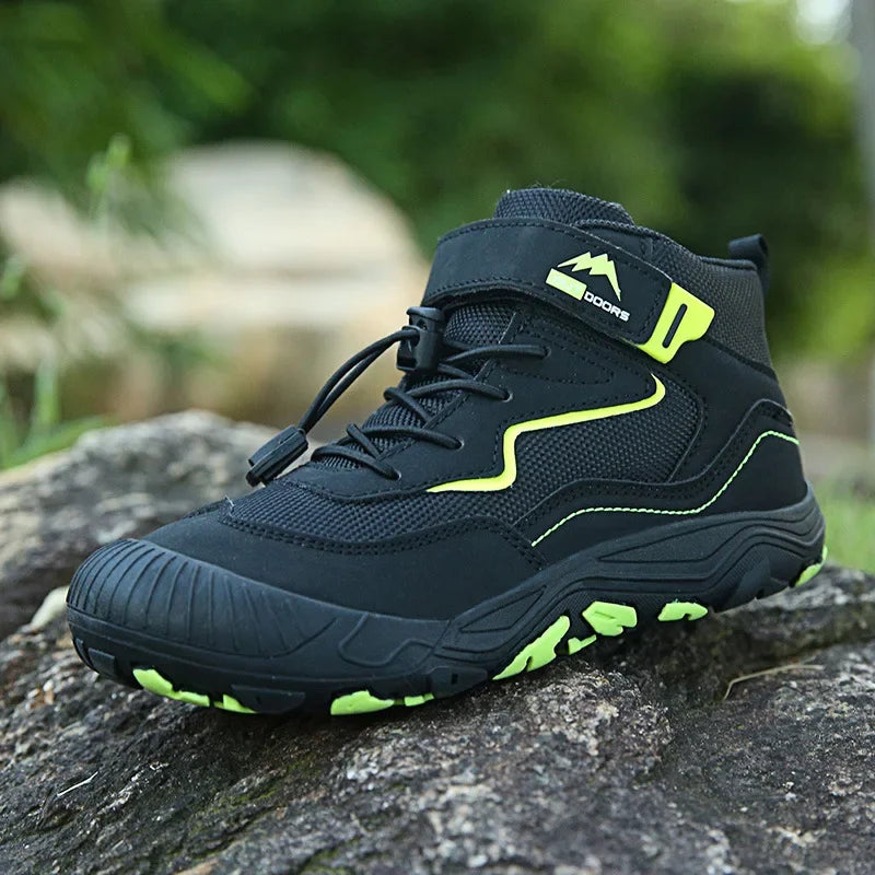 Black hiking boot with green accents on a rock