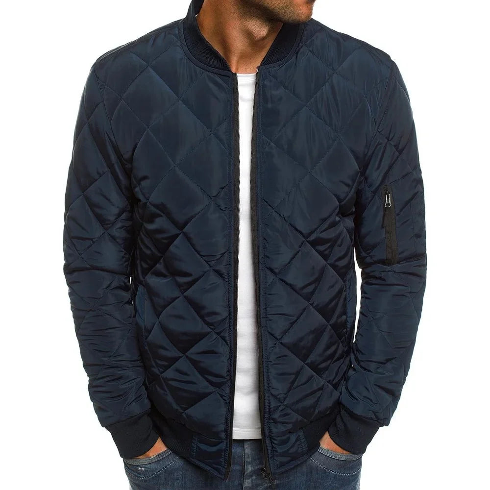 Navy quilted jacket worn by a person on a white background