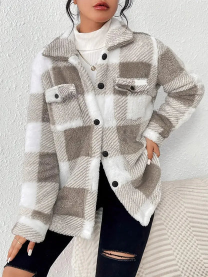 Person wearing a plaid patterned coat with a white background
