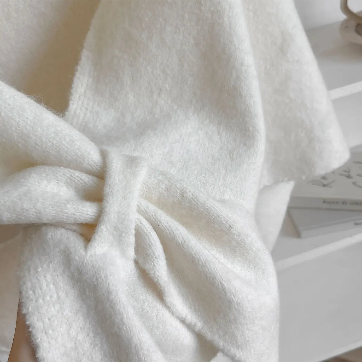 Close-up of a textured white fabric with a bow