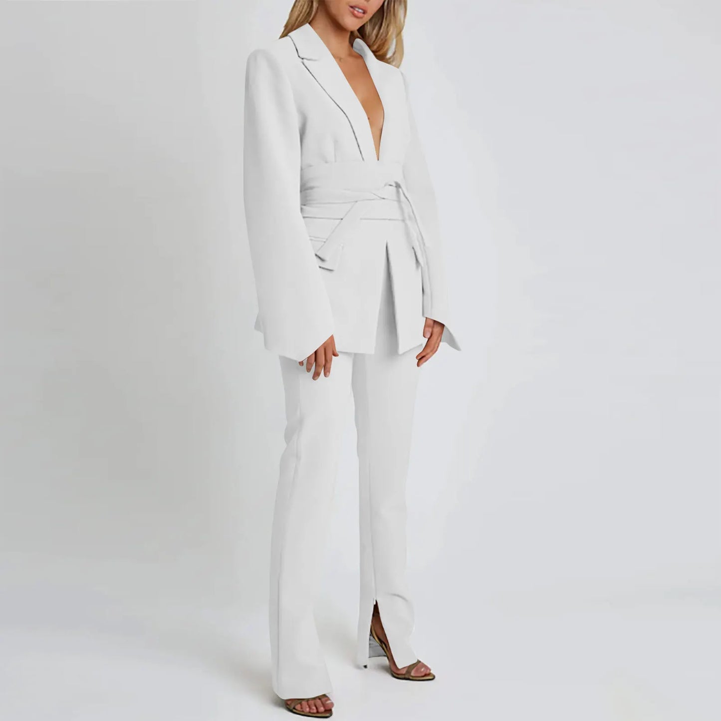 Woman wearing a white suit on a plain background