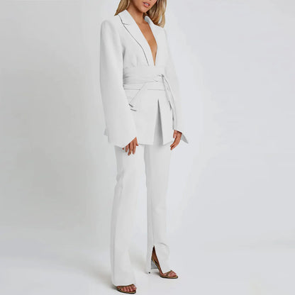 Woman wearing a white suit on a plain background
