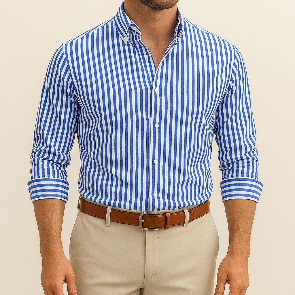 Man wearing a blue and white striped shirt with beige pants on a beige background