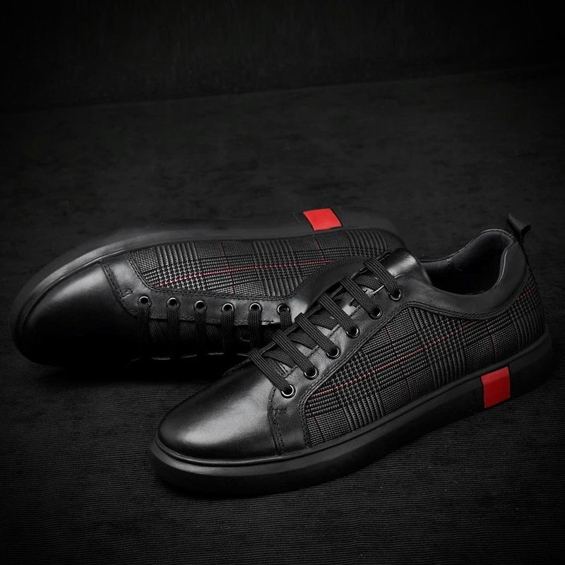 Black leather sneakers with red accents on a dark background