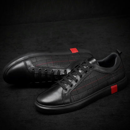 Black leather sneakers with red accents on a dark background