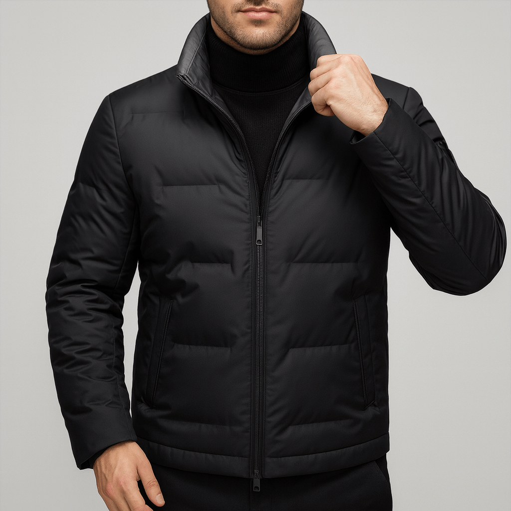 Man wearing a black puffer jacket on a gray background