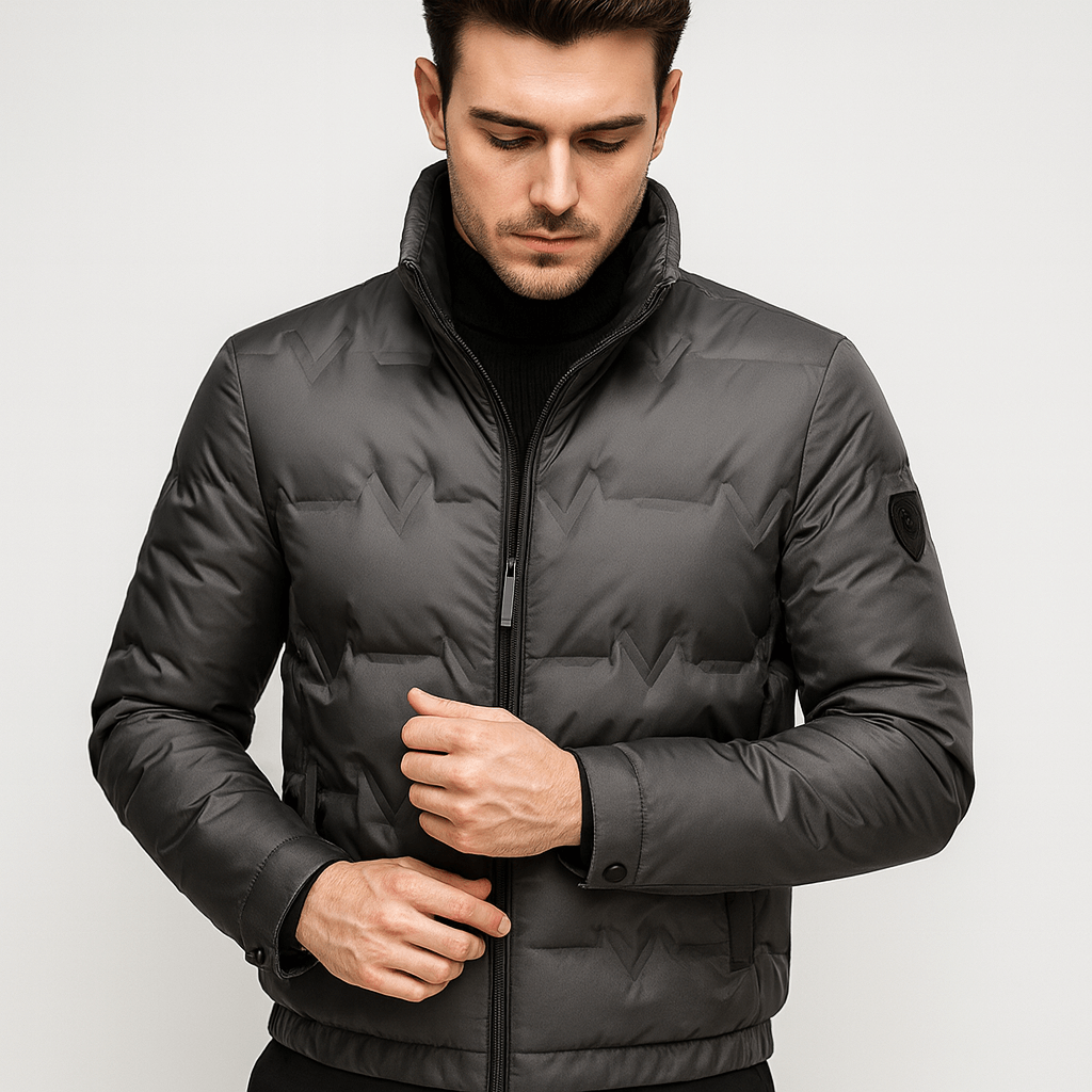 Man wearing a dark gray puffer jacket on a light gray background