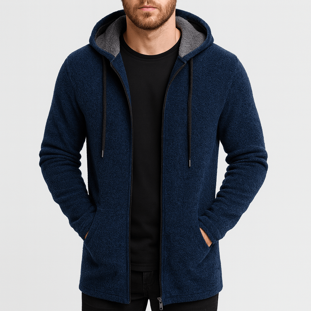 Man wearing a blue hoodie with gray lining on a light gray background