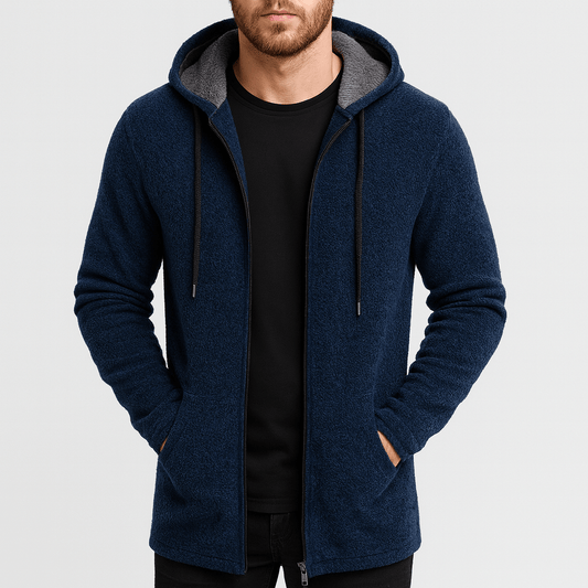 Man wearing a blue hoodie with gray lining on a light gray background