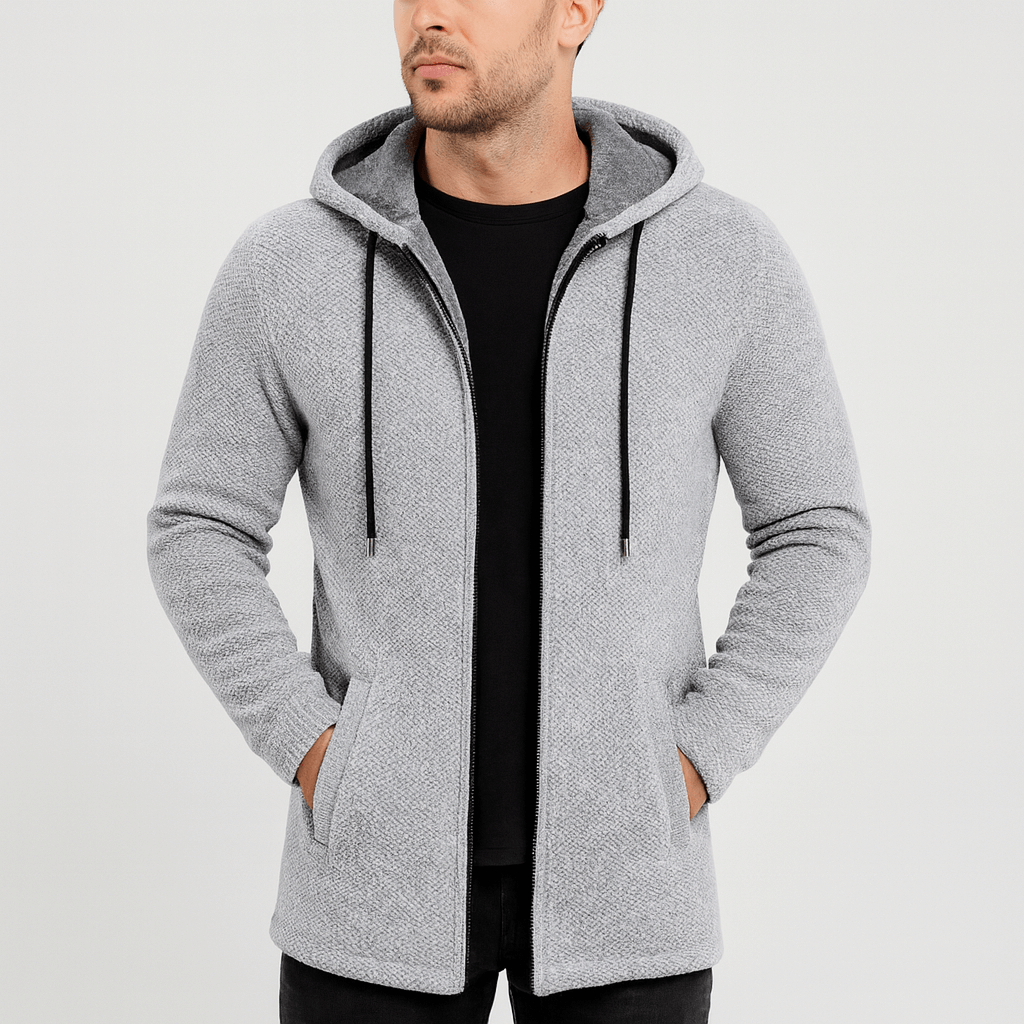 Man wearing a gray hooded jacket on a light gray background