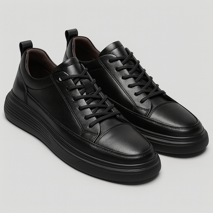 Pair of black leather sneakers on a light gray background