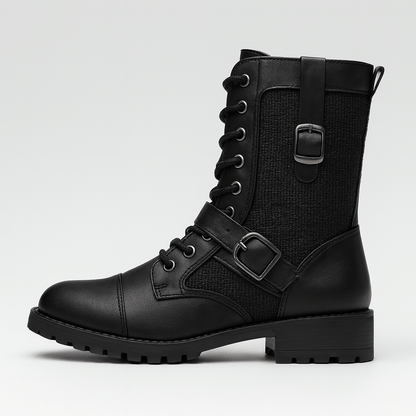 Black leather boot with buckles on a light gray background