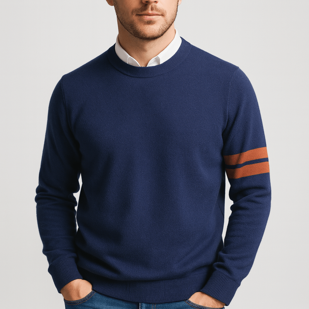 Man wearing a navy blue sweater with orange stripes on a light gray background