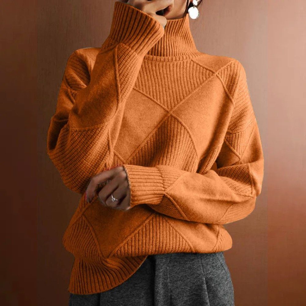 Person wearing an orange turtleneck sweater with dark pants