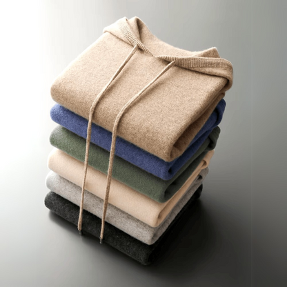 Stack of folded sweaters in various colors tied together on a gradient background