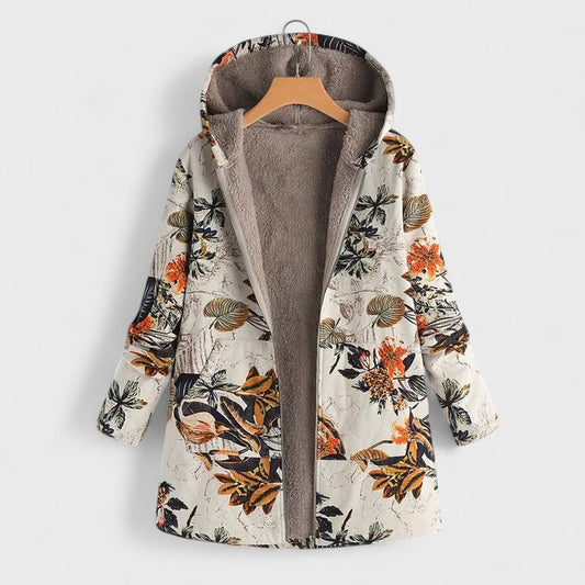 Floral patterned coat on a hanger against a white background