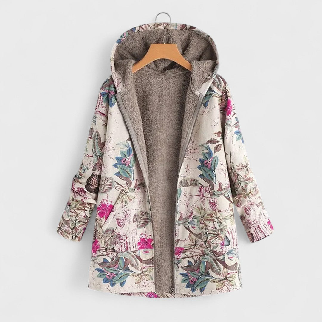 Floral patterned coat with a hood on a hanger against a white background