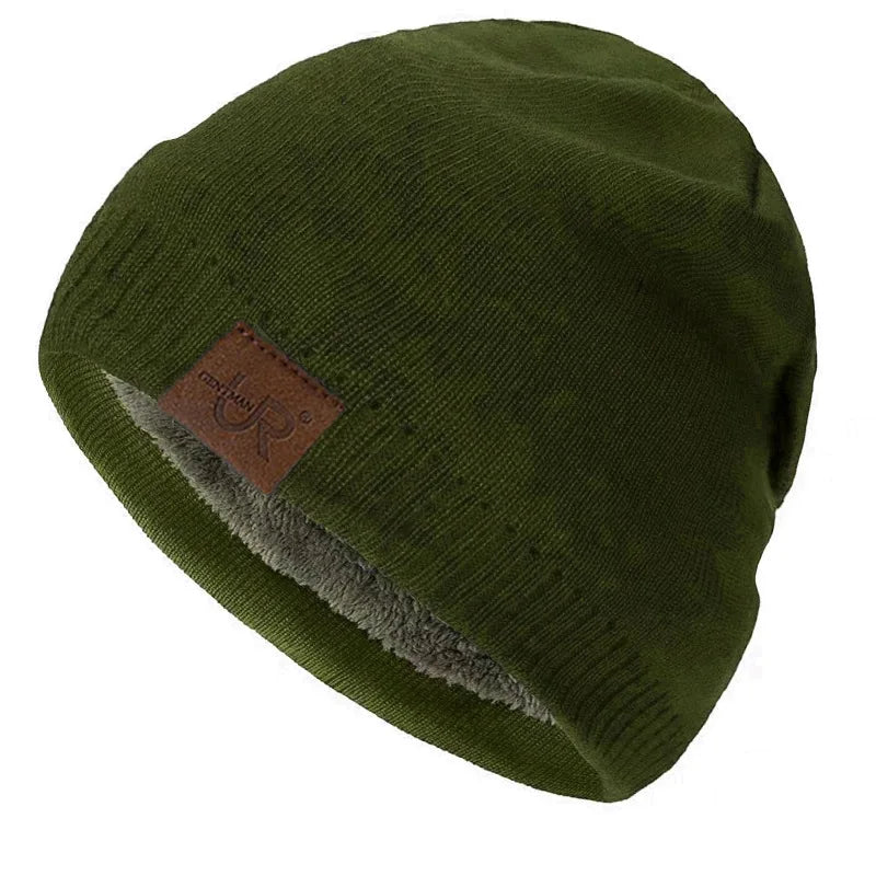 Green beanie with a brown leather patch on a white background