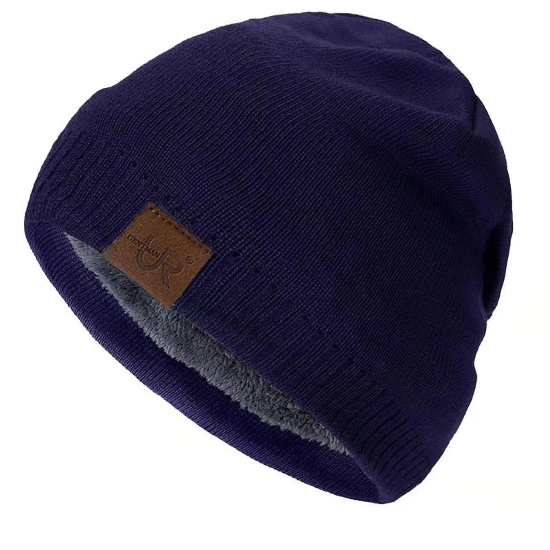Navy blue beanie with a brown leather patch on a white background