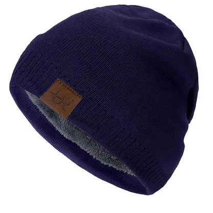 Navy blue beanie with a brown leather patch on a white background