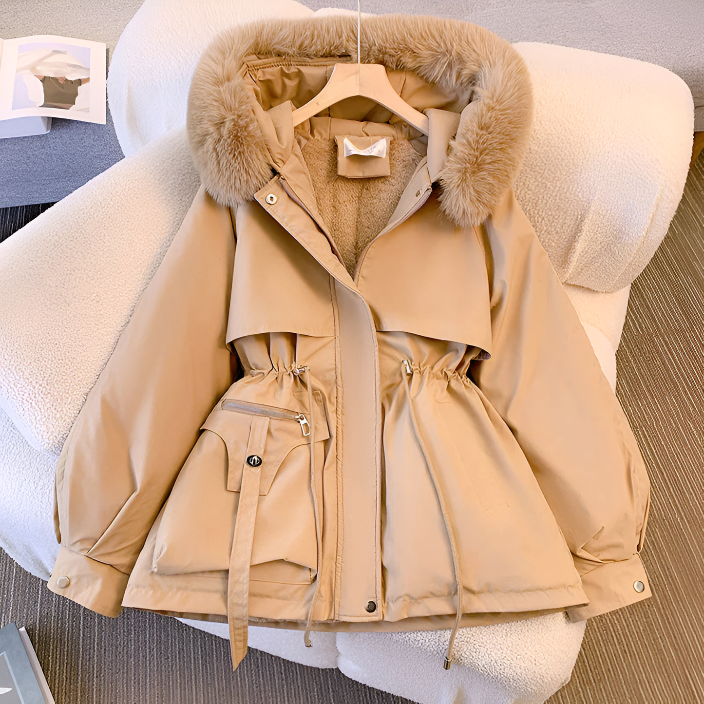 Beige parka with fur hood on a chair