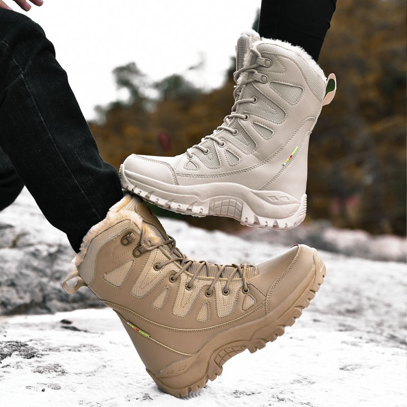Two pairs of hiking boots, one white and one beige, on a snowy ground with blurred natural background.