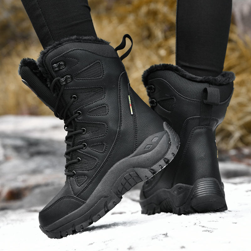 Black winter boots with fur lining worn on a snowy ground.