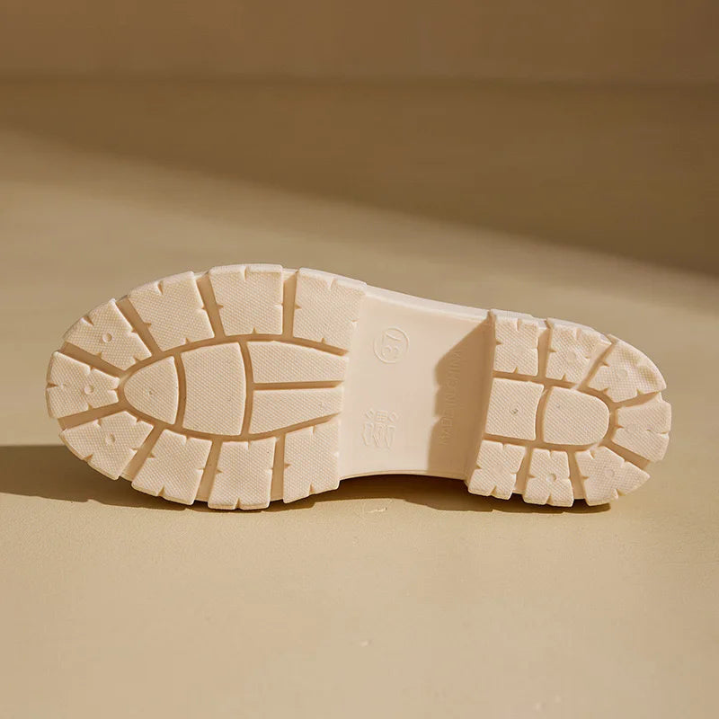 Close-up of a beige shoe sole on a matching beige background