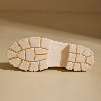 Close-up of a beige shoe sole on a matching beige background