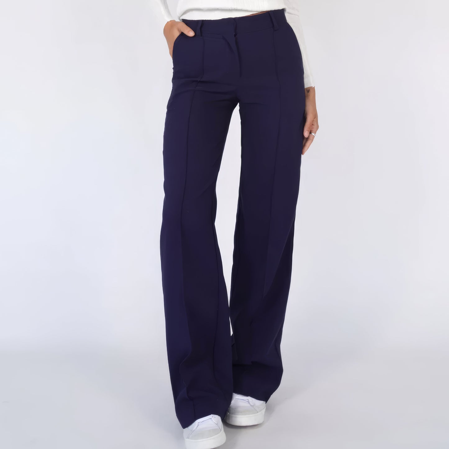 Navy blue wide-leg pants worn by a person on a white background