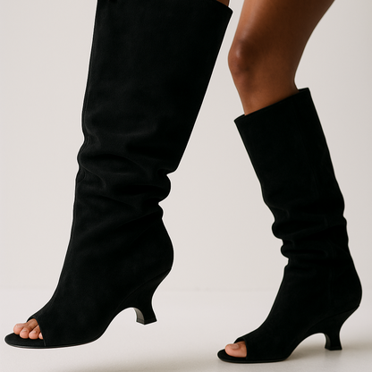 Black knee-high open-toe boots on a neutral background