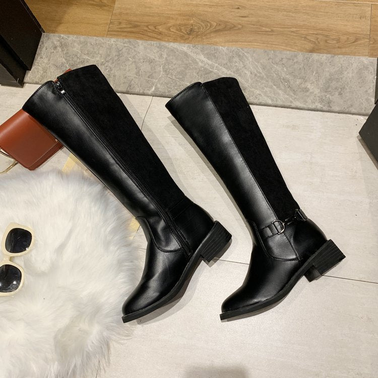 Black knee-high boots on a tiled floor with sunglasses and a wallet nearby.