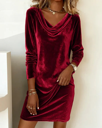 Red velvet dress worn by a person against a neutral background