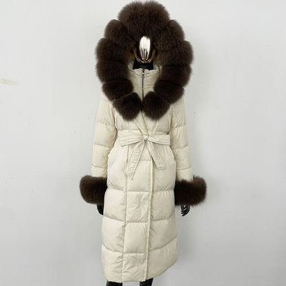 White puffer coat with large fur hood and cuffs on a white background