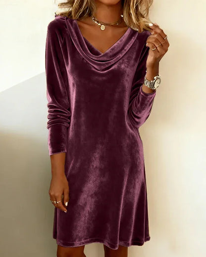 Purple velvet dress worn by a person against a plain background