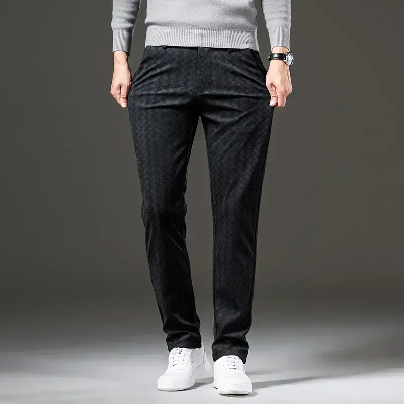 Person wearing black pants and a gray sweater on a gray background